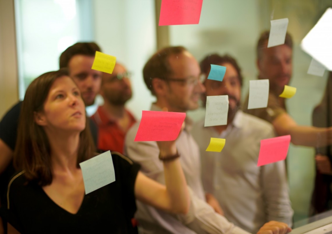salarié·es devant mur post-it