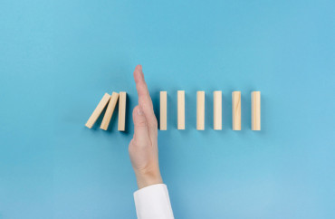 Main arrêtant des dominos